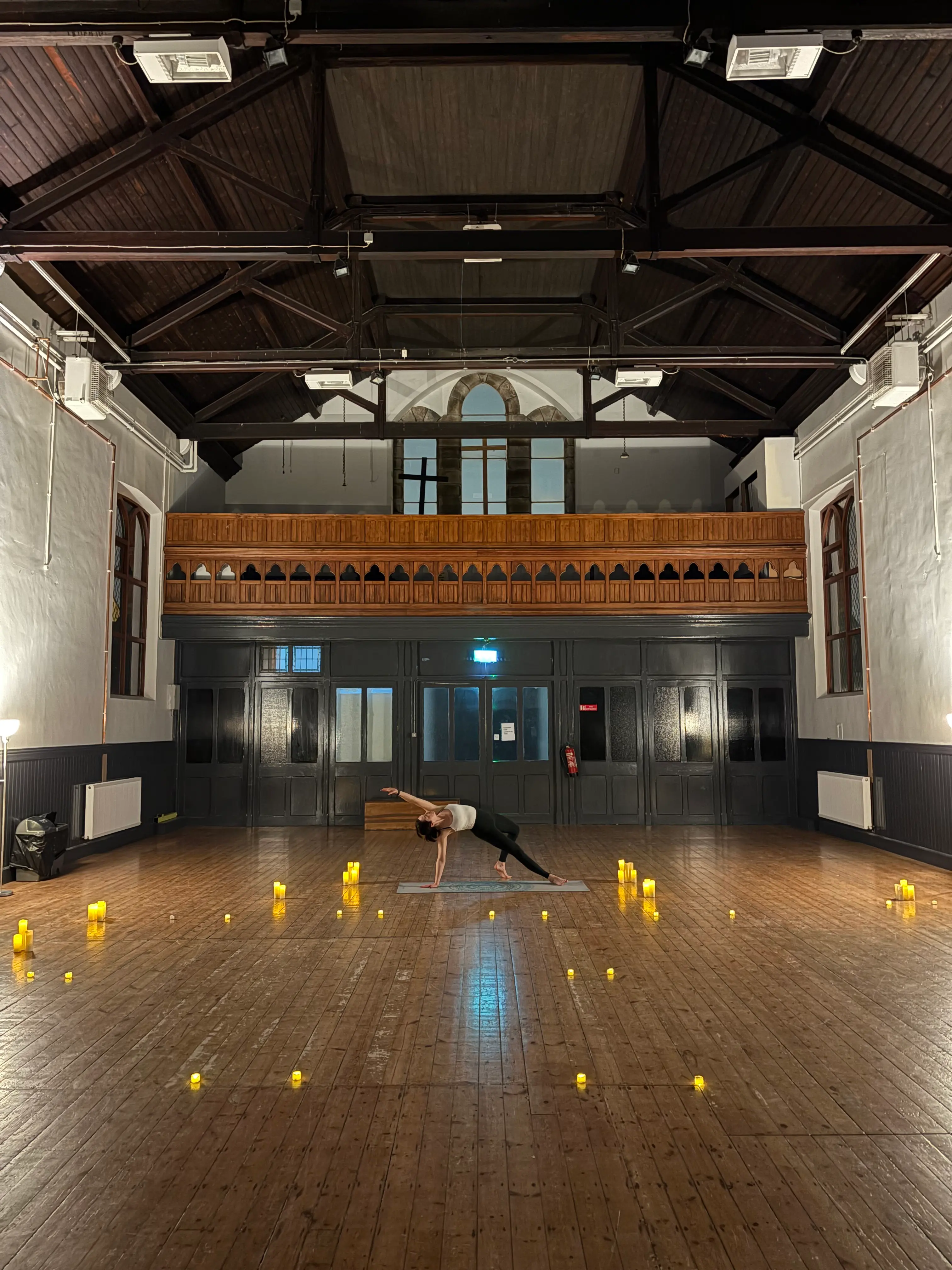 Peaceful yoga mat placed on a field with warm candlelit tones, representing the serene outdoor yoga experience